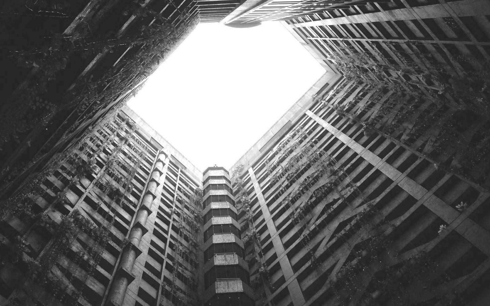 Looking up a building lightwell toward bright sky